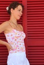 Woman stand near door with red jalousies