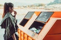 Woman stand near trash and she smell stinking dirty trash