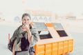 Woman stand near trash and she smell stinking dirty trash