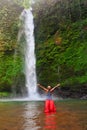 Woman stand in pool under waterfall, see on falling water Royalty Free Stock Photo