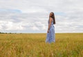 woman stand in summer field. feeling of freedom and happiness