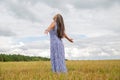 woman stand in summer field. feeling of freedom and happiness