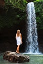 Woman stand under waterfall Royalty Free Stock Photo