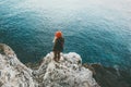 Woman standing above cold sea on cliff alone Travel Lifestyle concept outdoor Royalty Free Stock Photo