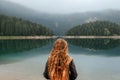 Woman Standing Alone on Shore of Mountain Lake Royalty Free Stock Photo