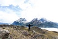 woman standing with arms wide open with Torres del Paine mountain range in the background Royalty Free Stock Photo