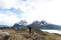 woman standing with arms wide open with Torres del Paine mountain range in the background Royalty Free Stock Photo