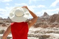 Woman holding hat looking at the Badlands of South Dakota. Royalty Free Stock Photo