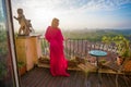 Woman standing on balcony in morning Royalty Free Stock Photo