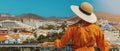 woman standing on balcony and enjoying view to the Playa de las Americas holiday resort skyline in Tenerife. copy Royalty Free Stock Photo