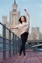 Woman is standing in ballet position