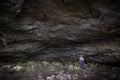 Woman standing in big cave on arran