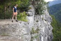Woman standing on big rock