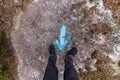 Woman standing at a blue painted direction arrow on the ground