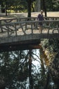 A woman standing on a bridge in an old park. Porto, Portugal. Royalty Free Stock Photo