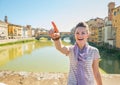 Woman standing on bridge overlooking ponte vecchio Royalty Free Stock Photo