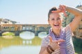 Woman standing on bridge overlooking ponte vecchio Royalty Free Stock Photo