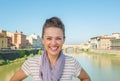 Woman standing on bridge overlooking ponte vecchio Royalty Free Stock Photo