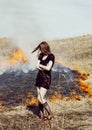 Woman standing in burning field, lifestyle people concept