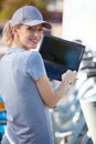 woman standing with city rent bicycle working with laptop