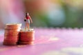 Woman standing on a coin Red background Financial concept