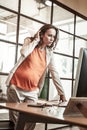 Concentrated pregnant office worker observing information on the screen