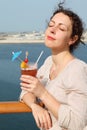 Woman standing on cruise liner with cocktail Royalty Free Stock Photo