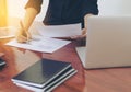 Woman standing at desk and working writing document hand close up.