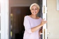 Woman standing in doorway of her house Royalty Free Stock Photo