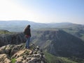 Woman standing on edge of a cliff