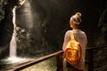 Woman standing at the edge and looking at wonderful scenery. Kozjak waterfall one of the beautiful waterfall in Slovenia. Popular