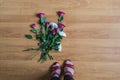 Woman standing on the floor among scattered flowers. Broken relationships in bad Valentine`s day. concept.