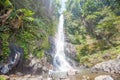 Woman standing in front of Gitgit waterfall Royalty Free Stock Photo