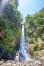 Woman standing in front of Gitgit waterfall Royalty Free Stock Photo