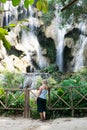 Woman standing in front of Kuang Si waterfall close to Luang Prabang, Laos Royalty Free Stock Photo