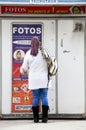 Woman standing in front of a machine to make passport photos.