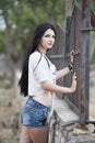 Woman standing front of metal garden fencing Royalty Free Stock Photo