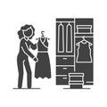 Woman standing in front of opened wardrobe with apparel hanging inside black glyph icon. Home leisure. Vector isolated