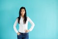 Woman standing in front of turquoise wall