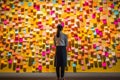 A woman standing in front of a wall full of sticky notes, neural network generated photorealistic image Royalty Free Stock Photo