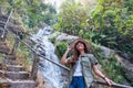 A woman standing in front of waterfall in the jungle Royalty Free Stock Photo