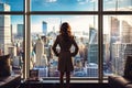 Woman Standing in Front of Window, Looking Out at City Royalty Free Stock Photo