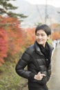 Woman standing in garden in autumn Royalty Free Stock Photo