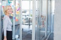 Woman standing at glass wall in office with notes, color wheel and annotations, copy space Royalty Free Stock Photo