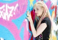 woman standing at graffitti wall