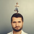 Woman standing on the head of displeased man Royalty Free Stock Photo