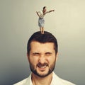 Woman standing on the head of dissatisfied man Royalty Free Stock Photo