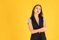 The woman is standing with her arms crossed and smiling. There is space to put messages. In the yellow background Royalty Free Stock Photo