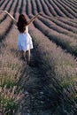 a woman standing with her back in a field of lavender walk nature