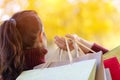 A woman standing with her back and holding the colorful packages . Royalty Free Stock Photo